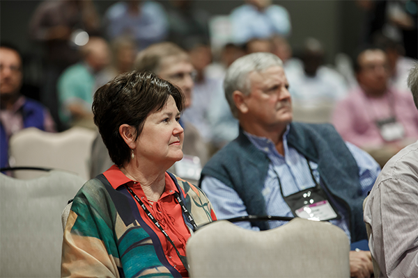 Close-up shot of a woman attending a conference session