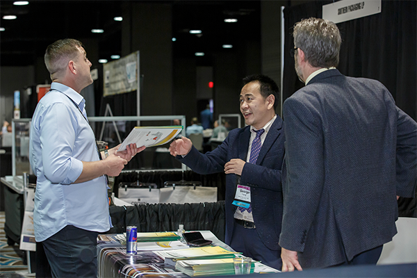 Man speaking with exhibitors