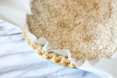Close up view of raw rice grains used as pie crust weights.