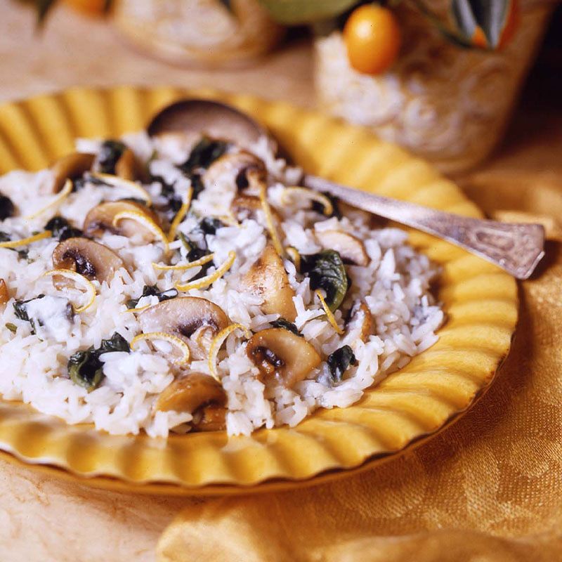 Gorgonzola Lemon Rice topped with Mushrooms on a yellow plate. 