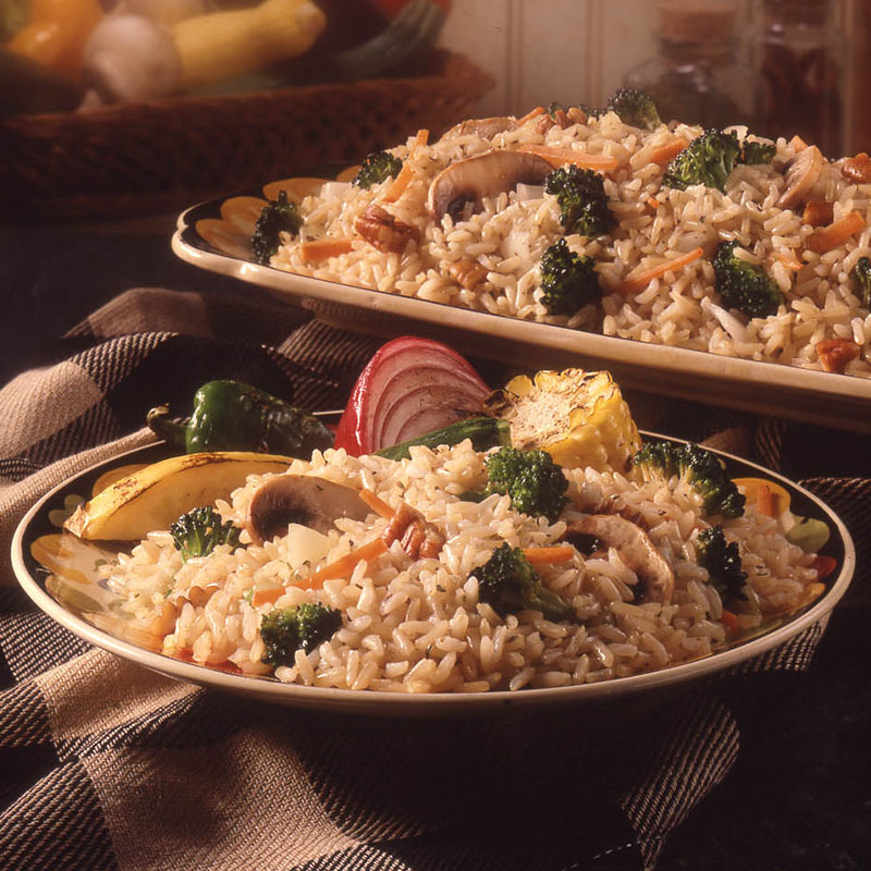 Side view of nutty vegetable rice pilaf on a large serving platter.