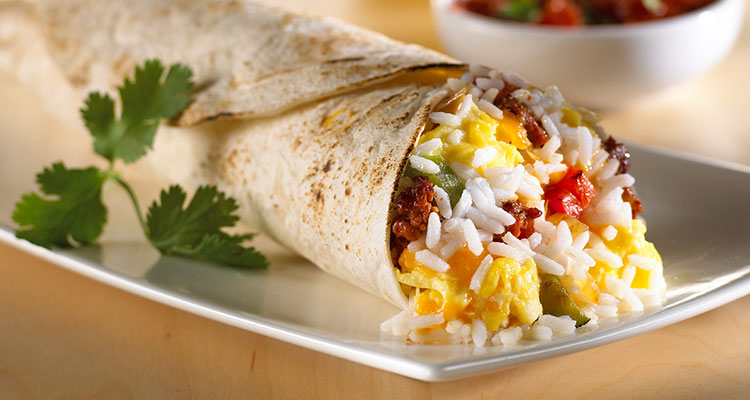 Chorizo, Rice, and Egg Wrap Side view of Chorizo, Rice, and Egg Wrap on a white plate.