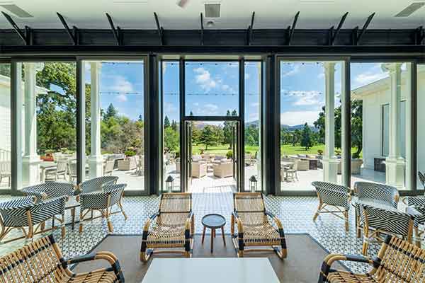 Room with large windows and an abundance of seating for resort guests.