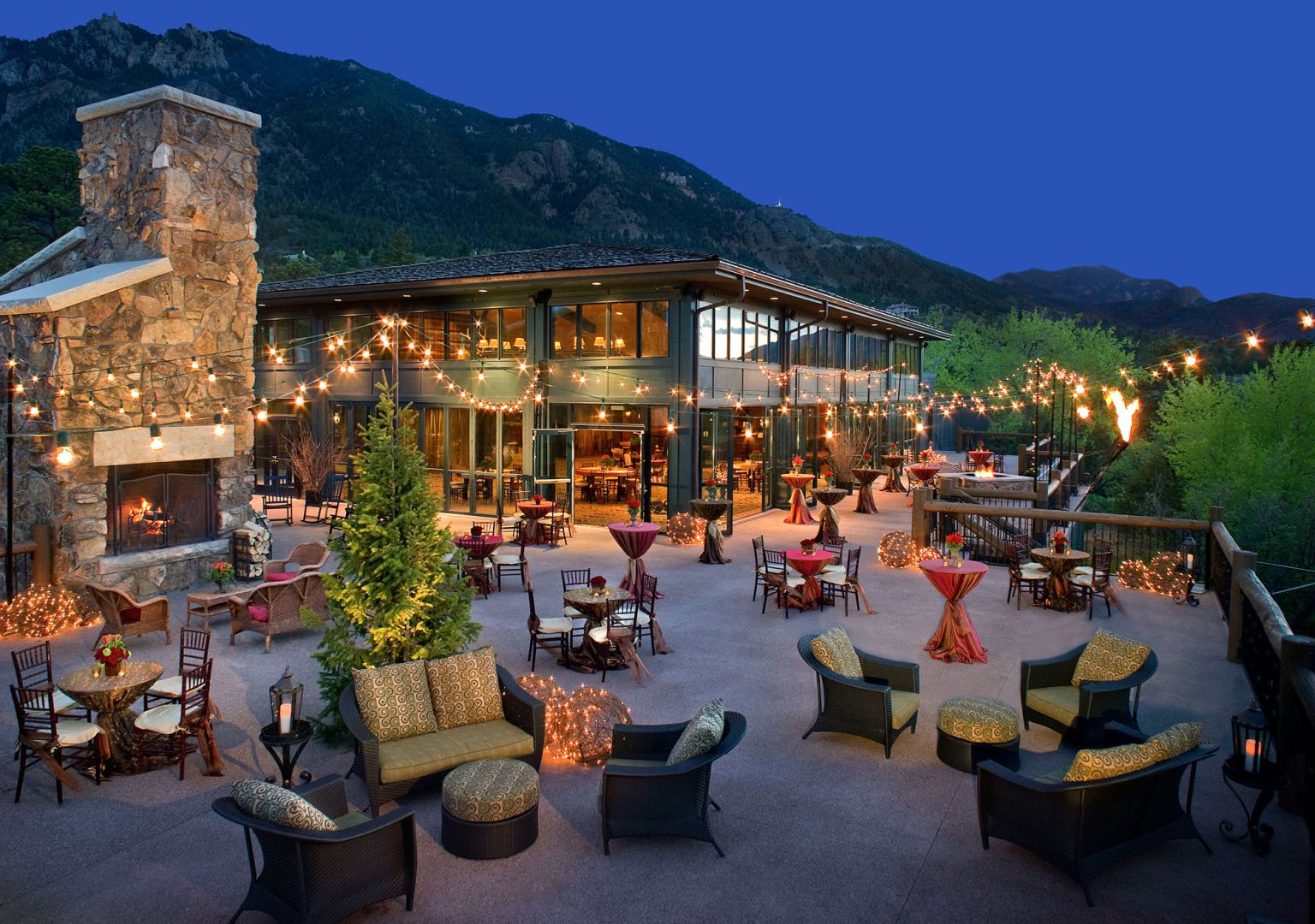 Outdoor lounge at dusk with warm twinkle lights