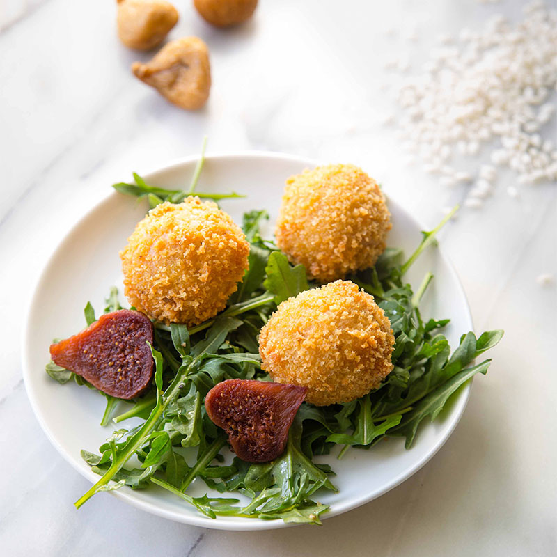 Plate of three Fig & Prosciutto Arancini.