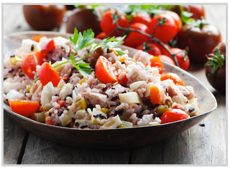 Side view of a healthy rice salad in a serving bowl.