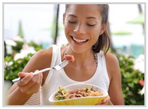 Young woman eating a healthy rice bowl.