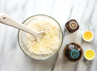 Overhead view of raw rice grains and essential oils.