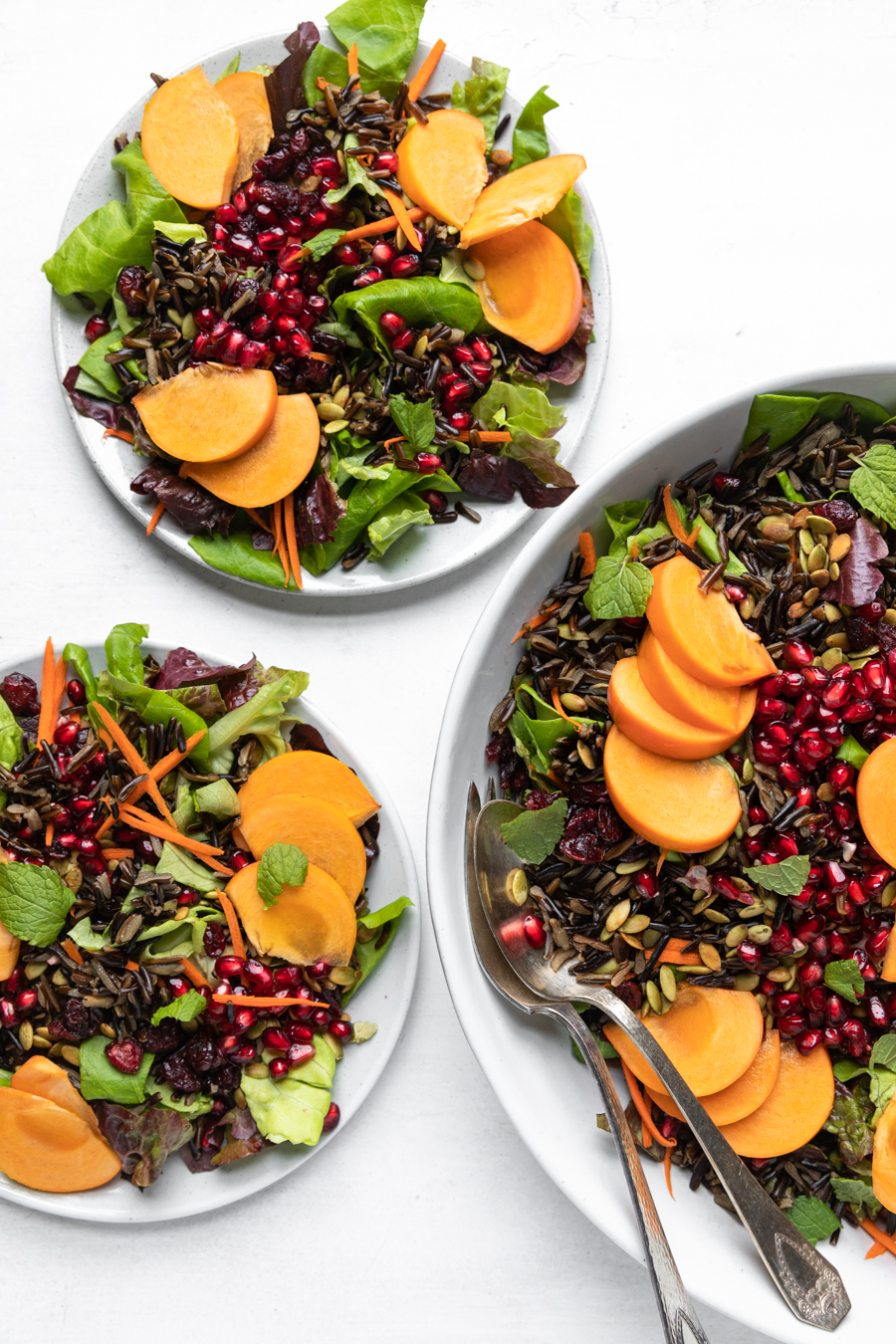 Overhead shot of three bowls of Holiday Wild Rice Salad.