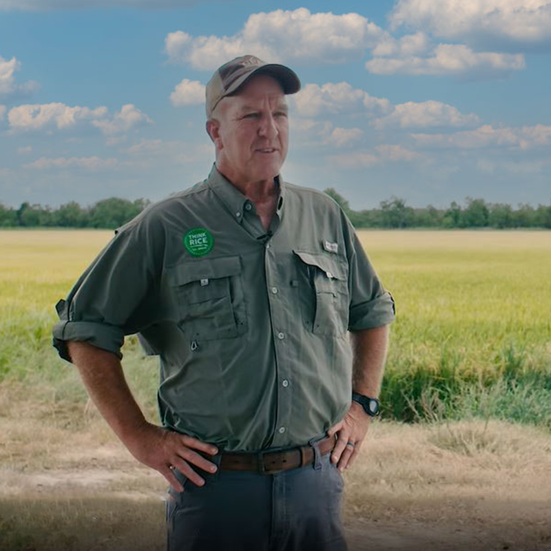 Rice farmer Fred Zaunbrecher standing in front of a field.