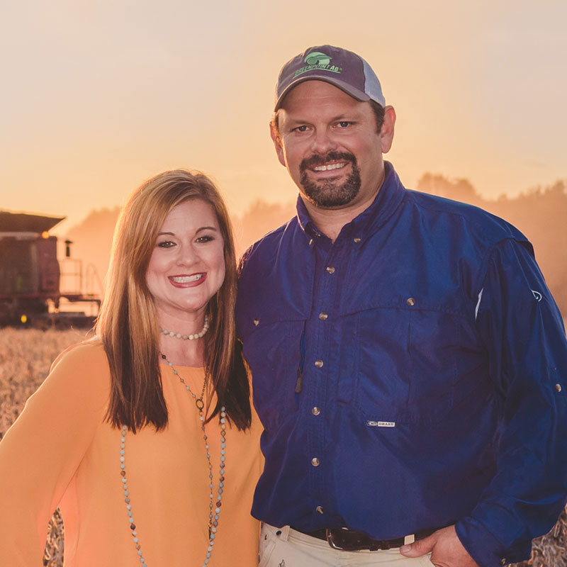 Rice farmer Jason Waller standing with his wife in a field.