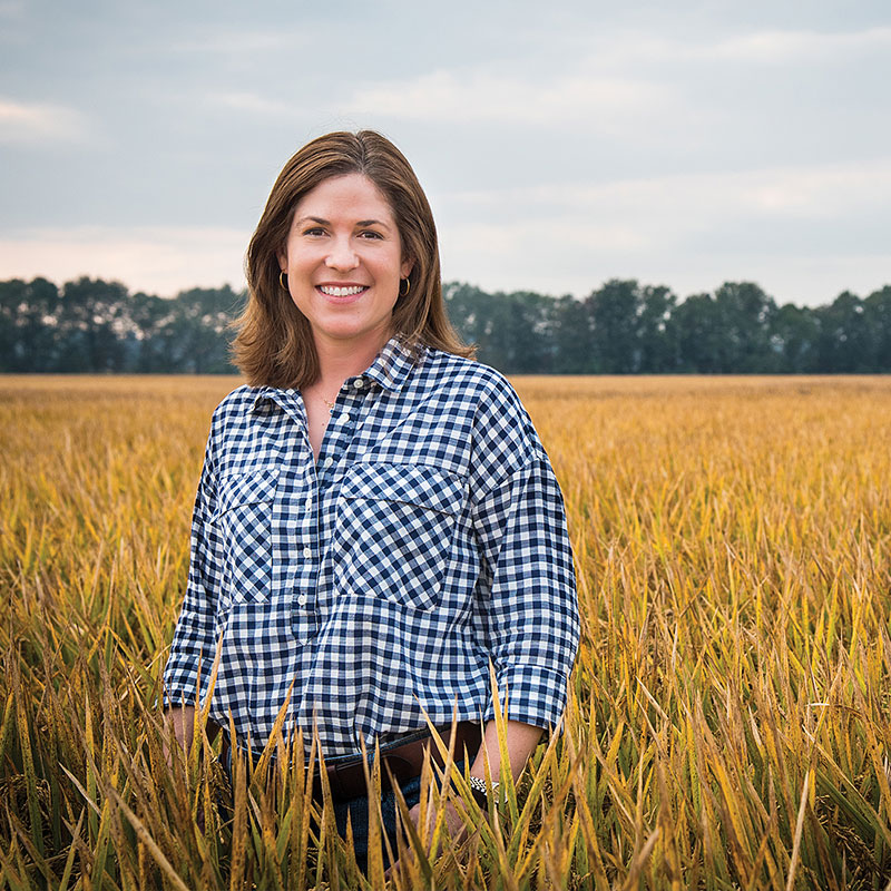 Rice farmer, Jennifer James, standing in a rice field.