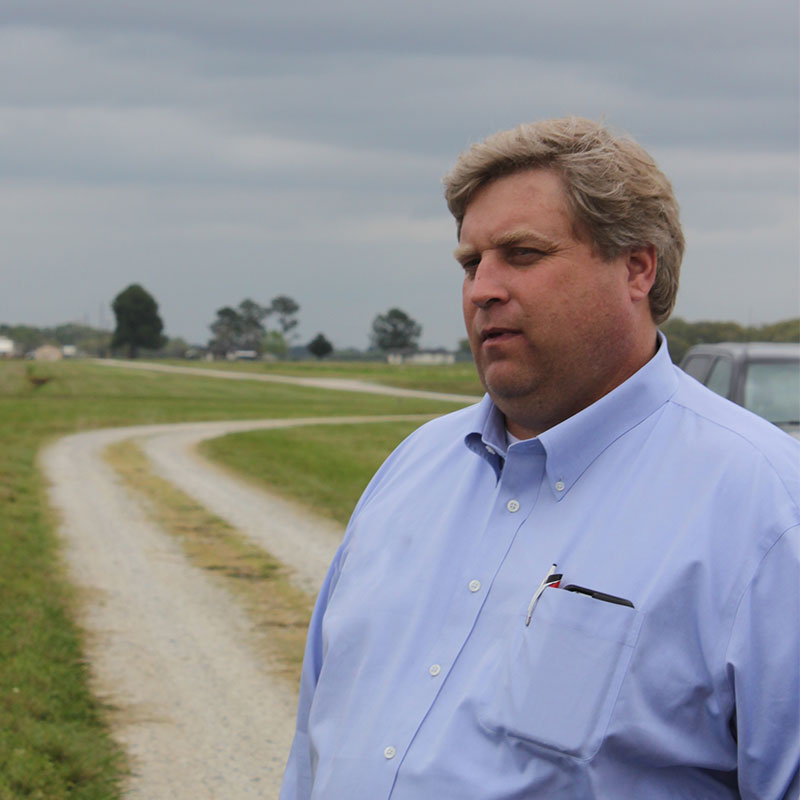 Rice farmer, Nat McKnight, standing on a country road.