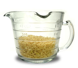 Side view of a measuring cup filled with rice.