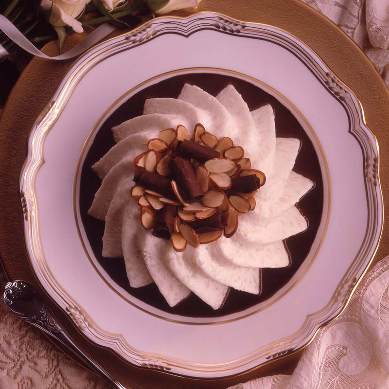 Bavarian Rice Cloud with Bittersweet Chocolate Sauce Overhead view of Bavarian rice cloud with bittersweet chocolate sauce on a white plate.