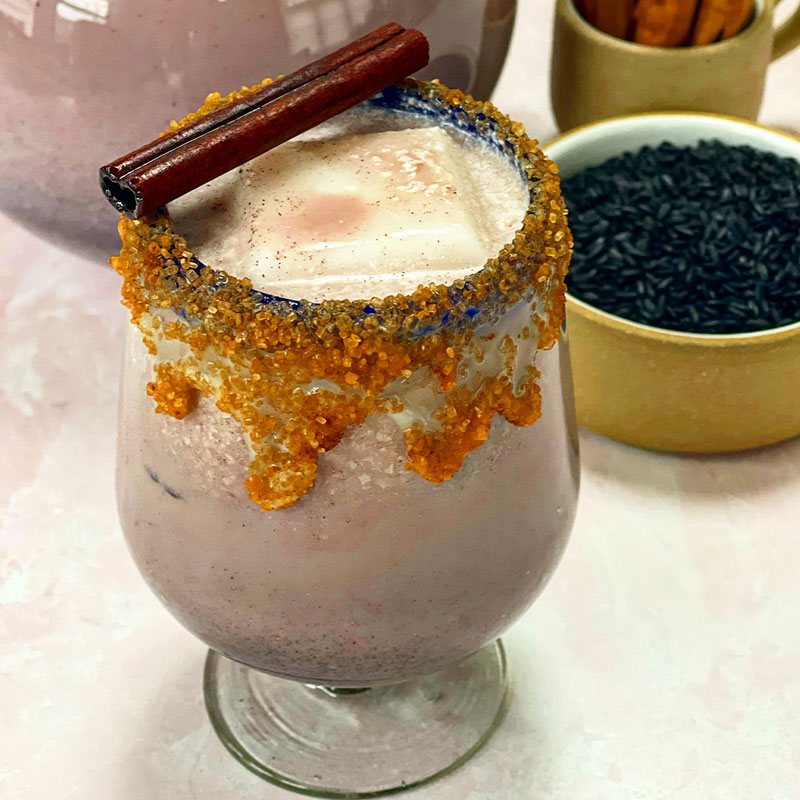 A cup of Black Rice Horchata with a sugar rim. 