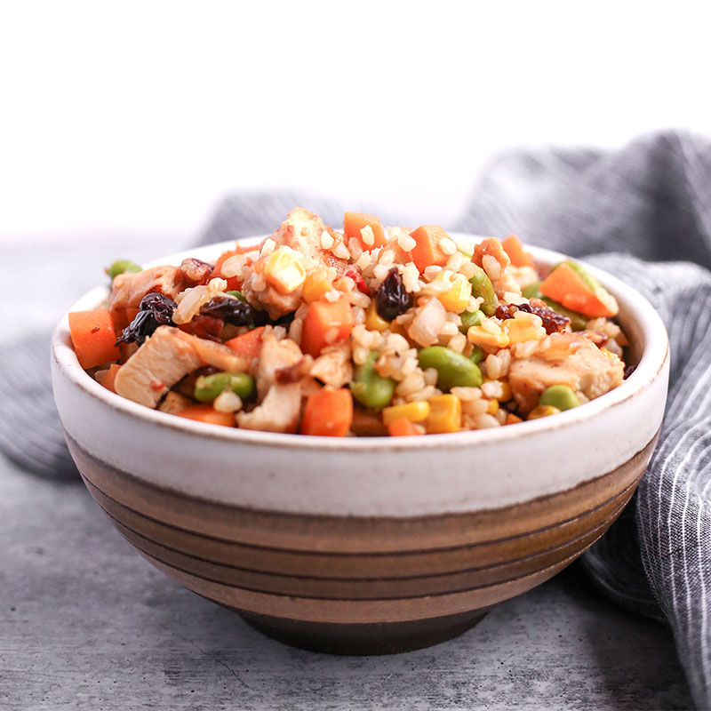 Side view of brown rice and sweet potato hash in a bowl.