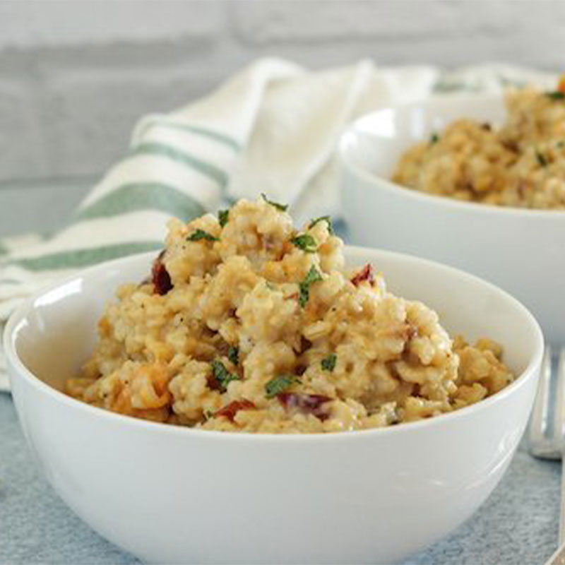 Side view of two white bowls filled with Risotto mix.