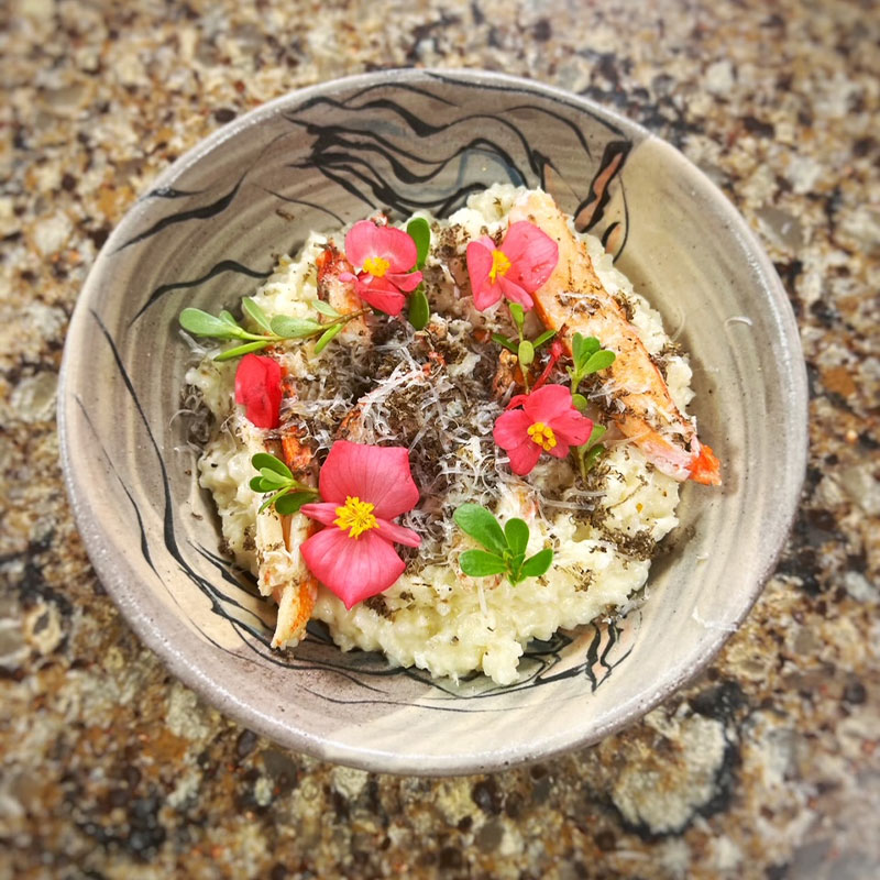 Overhead view of a bowl of Carolina Gold Rice Grits with Snow Crab.