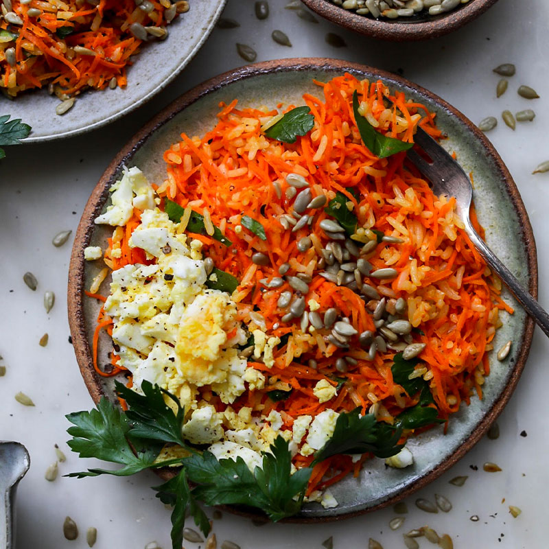 Overhead shot of a colorful Carottes Râpées with Rice and Sunflower Seeds