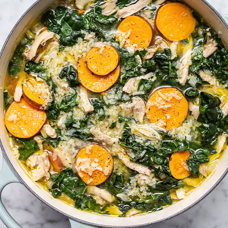 Overhead shot of a pot full of Chicken, Rice, and Kale Soup.