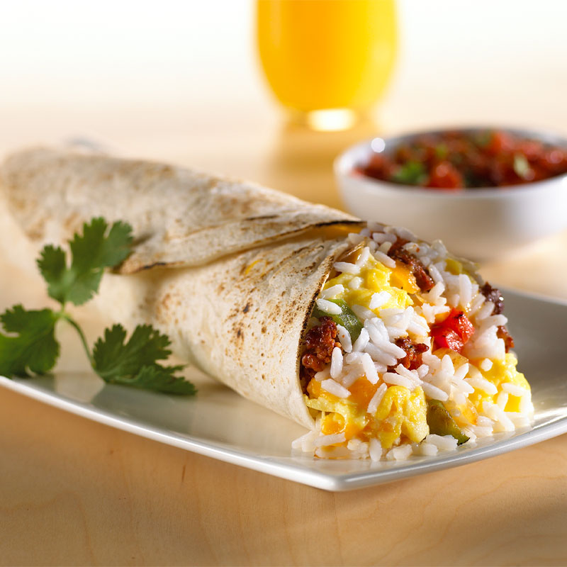 Side view of one Chorizo, Rice & Egg Wrap on a white plate.  