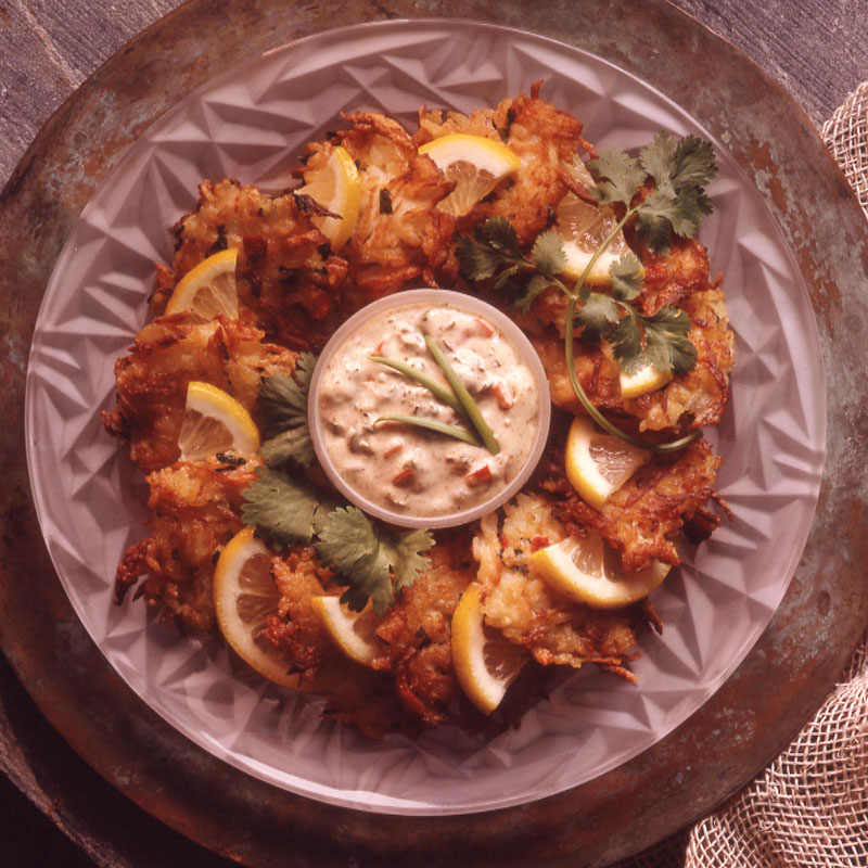 Overhead view of crab rice cakes on a white platter.