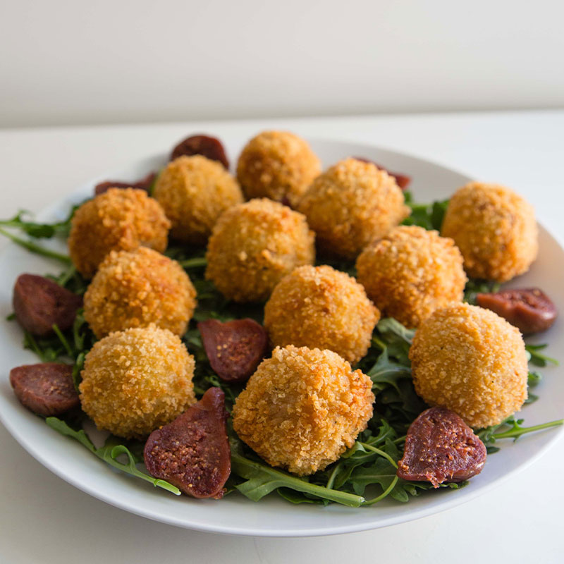 California Fig and Prosciutto Arancini A plate full of California Fig and Prosciutto Arancini