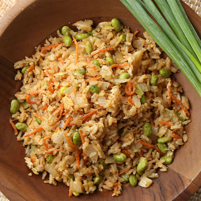 Overhead view of Fried Rice Stir Up with green onions talks to the side.