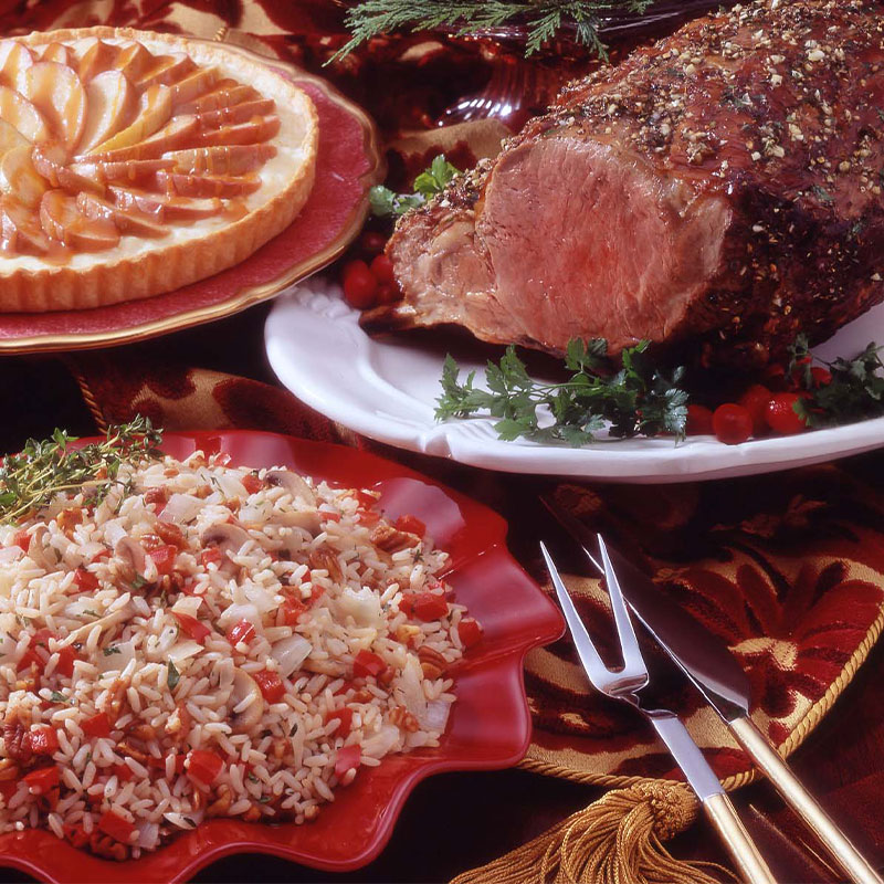 Holiday Nut & Herb Pilaf Holiday Herb and Nut Pilaf in a festive red serving dish.