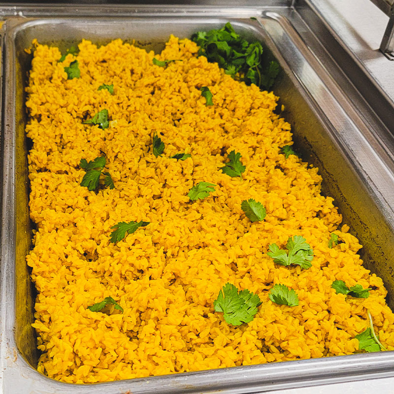 K-12 Tumeric Rice A steam pan of K-12 Tumeric Rice.
