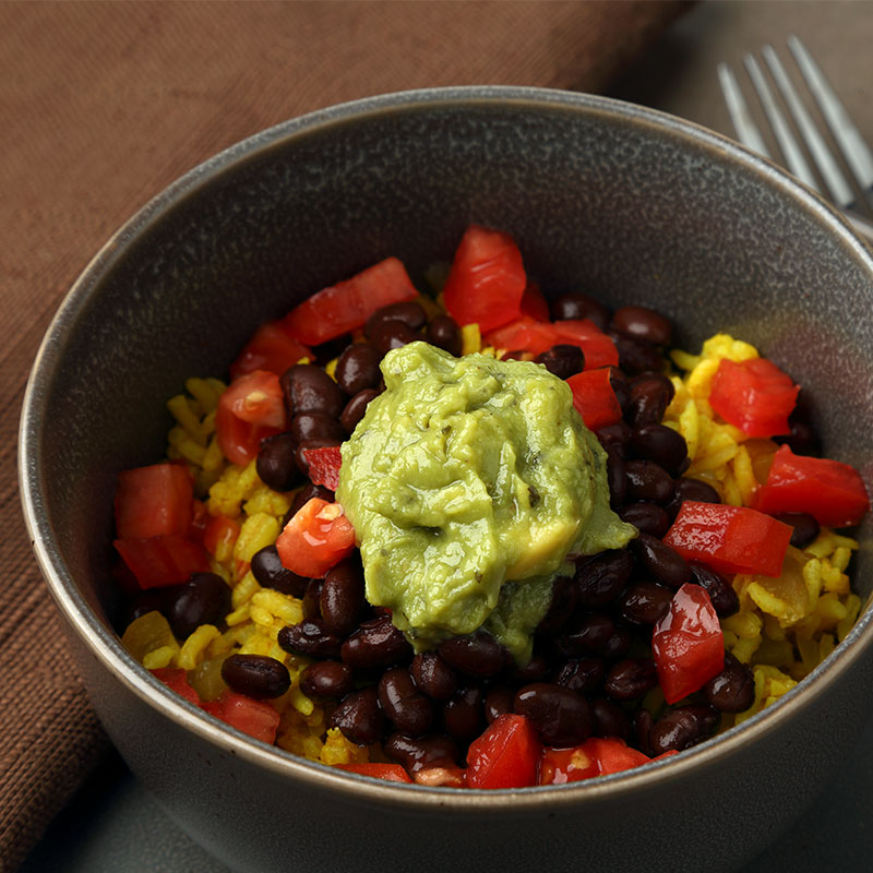 Overhead view of layer black bean and rice casserole in a grey bowl.