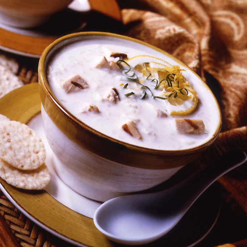 Side view of lemon velvet chicken and rice soup in a bowl.