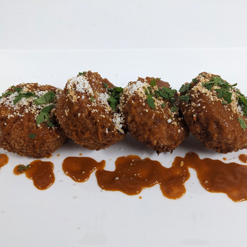 A serving of four Mexican Breaded Rice Patties.