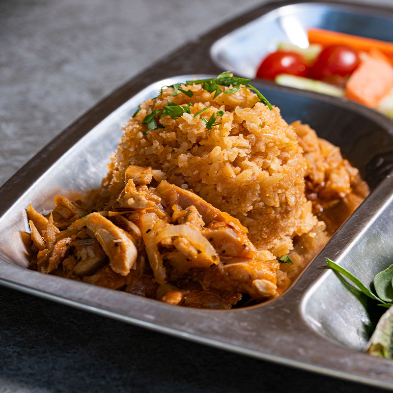 Focused image of a scoop of Mexican Red Rice.