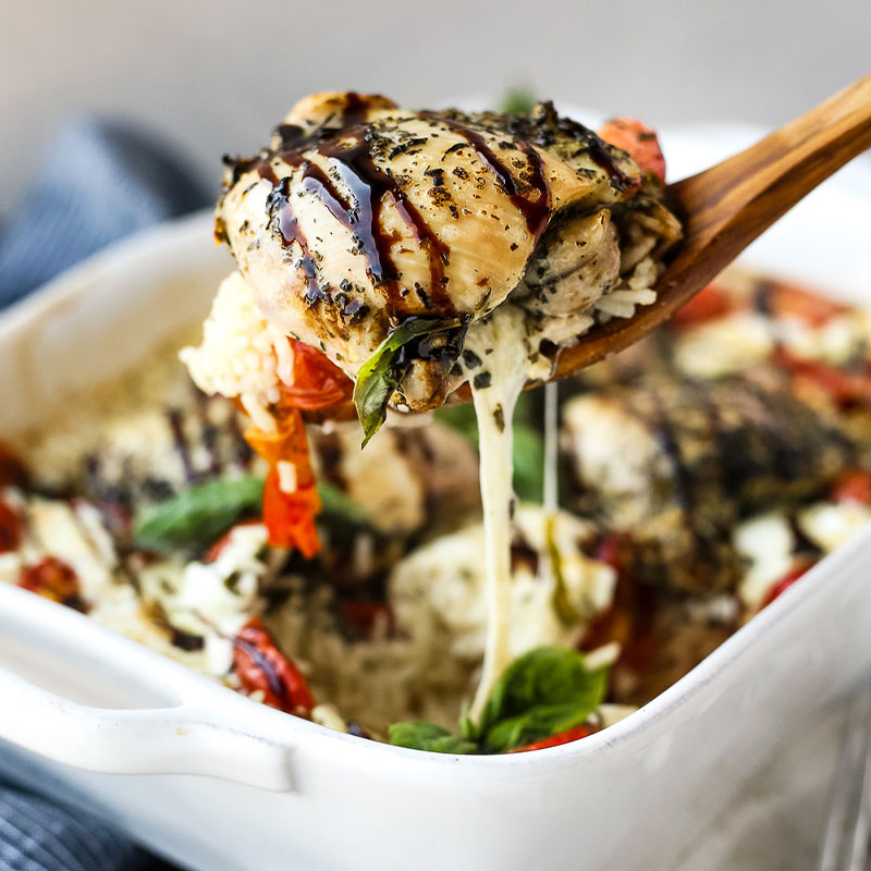 Zoomed in shot of a spoonful of One-Pan Caprese Chicken and Rice Bake