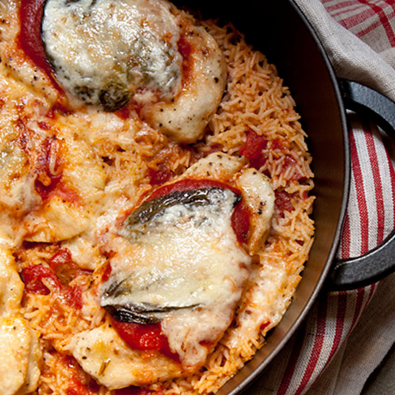 Overhead view of chicken and rice parm in a skillet.