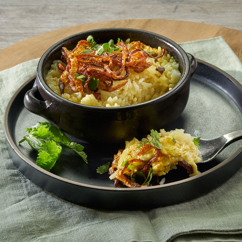 Paneer Biryani A serving of Paneer Biryani with a spoonful exposed.