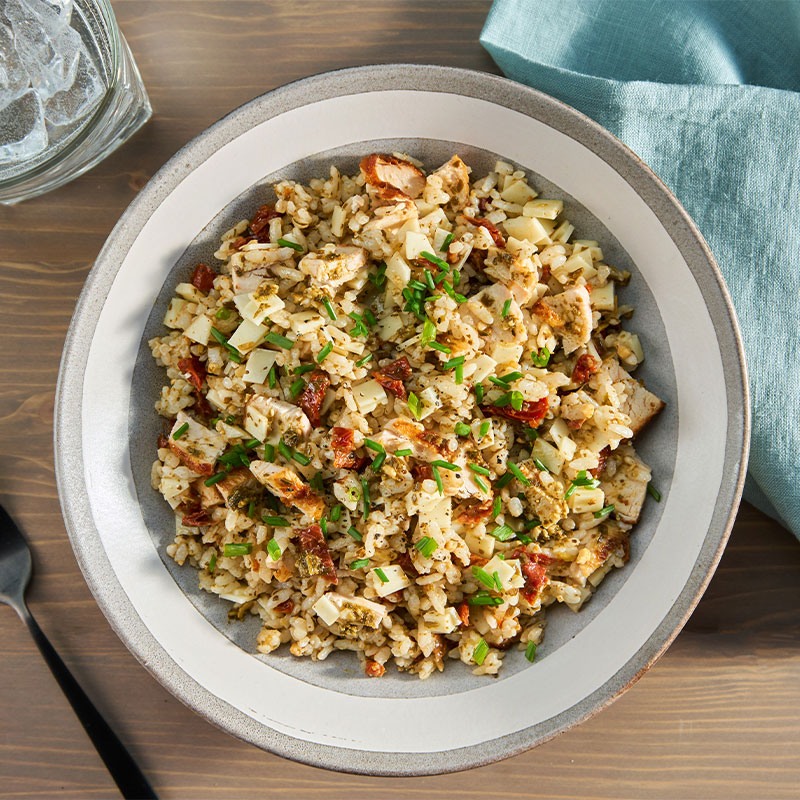 Overhead shot of a bowl of Pesto Chicken & Rice Salad with Tuscan Relish