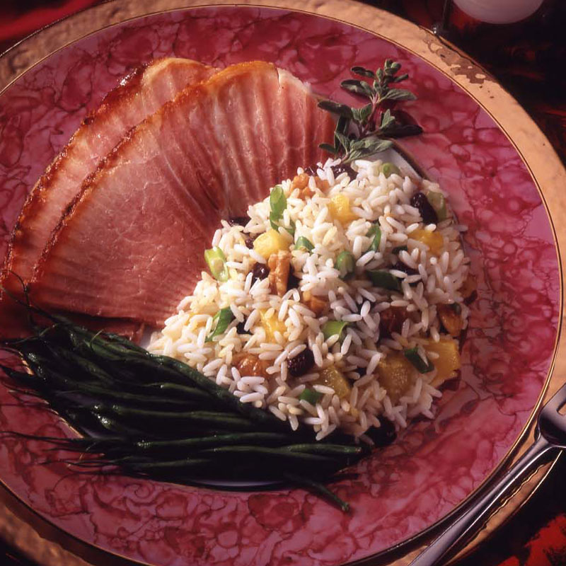 Overhead view of pineapple rice pilaf with ham and green beans.