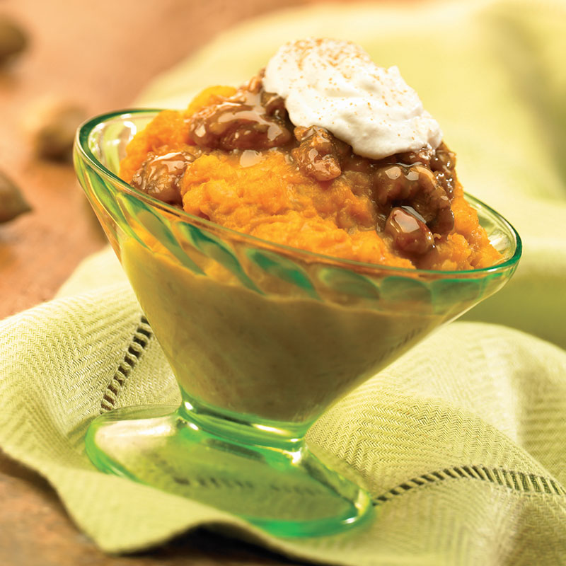 Side view of praline pumpkin rice pudding in a glass dish.