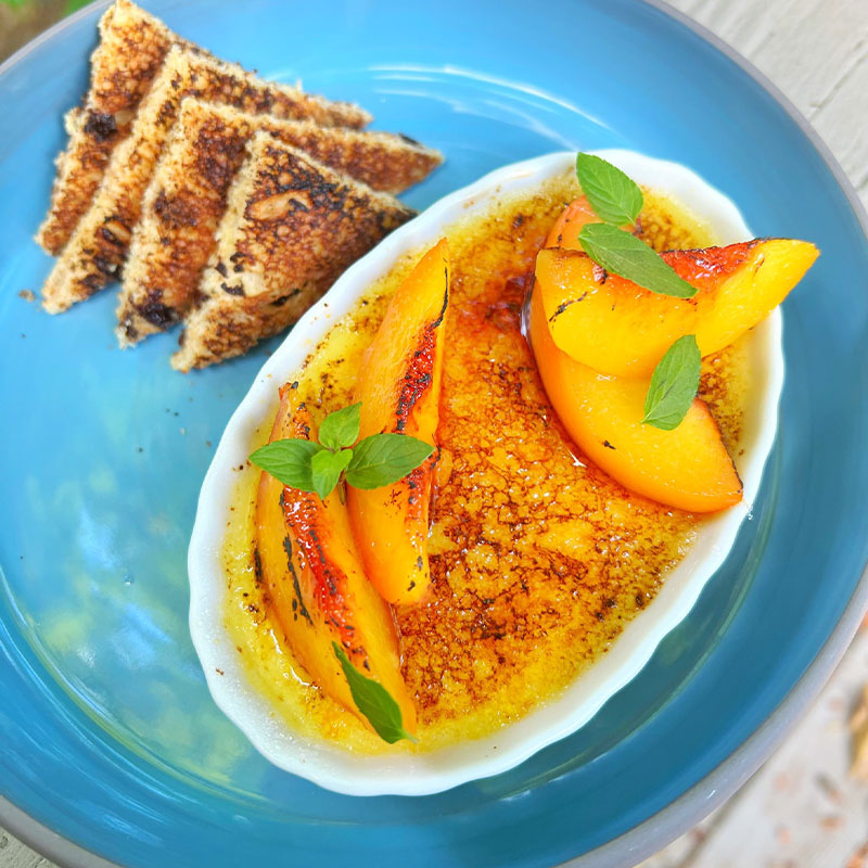 Rice Pudding Creme Brulee with toast points on a blue plate.