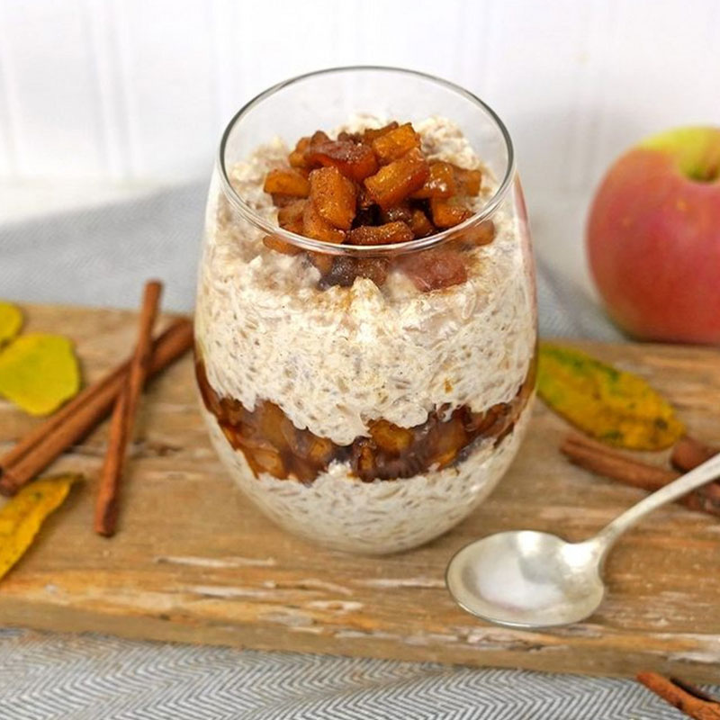 Rice Pudding with Bourbon Glazed Apples One serving of Rice Pudding with Bourbon Glazed Apples in a glass cup.