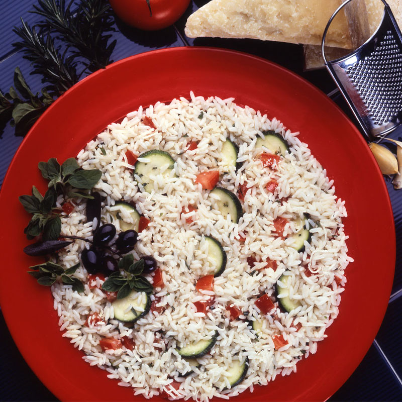 Rice Salad Milano Overhead shot view of Rice Salad Milano in a red bowl.