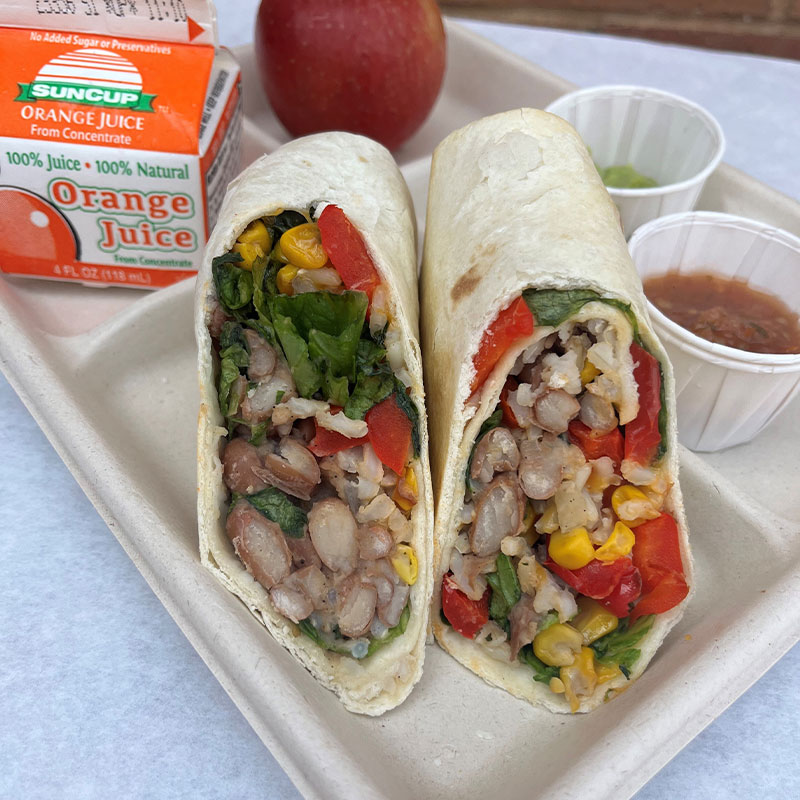 Roasted Veggie and Bean Burrito Roasted Veggie and Bean Burrito on a cafeteria tray.