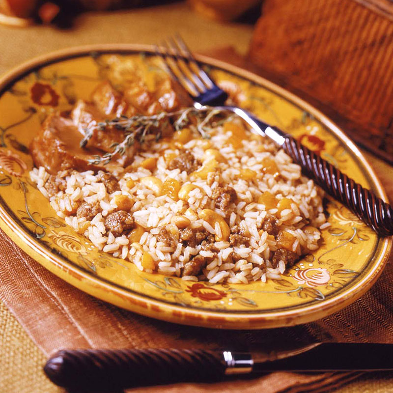 Sausage & Apricot Balsamic Rice Side view of sausage and apricot balsamic rice on a yellow plate.