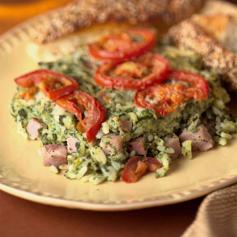 One piece of Savory Spinach and Rice Casserole on a yellow plate.