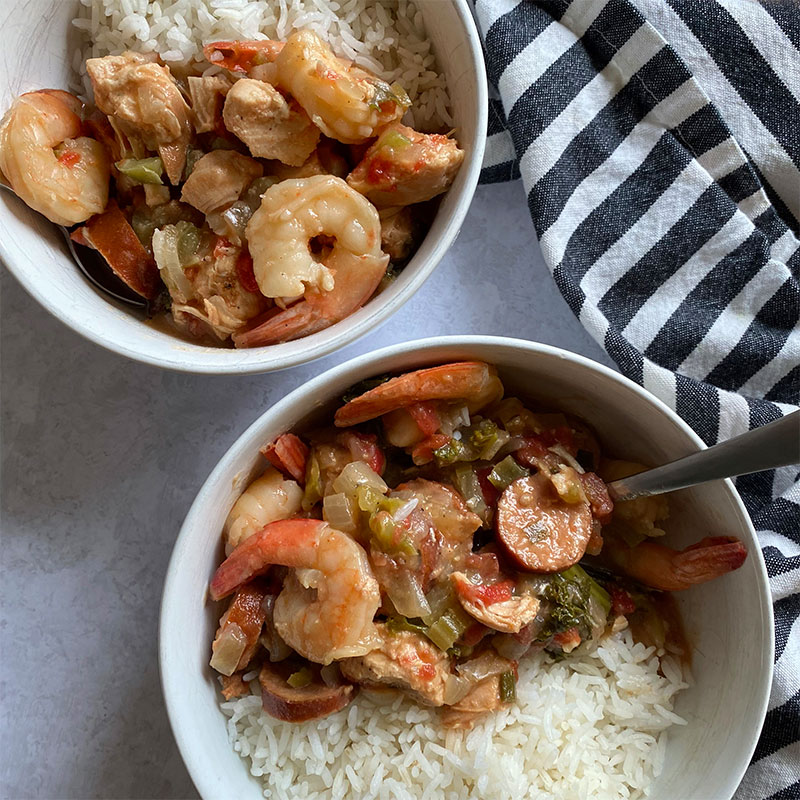 Overhead view of two bowls of Shrimp Gumbo served with rice.