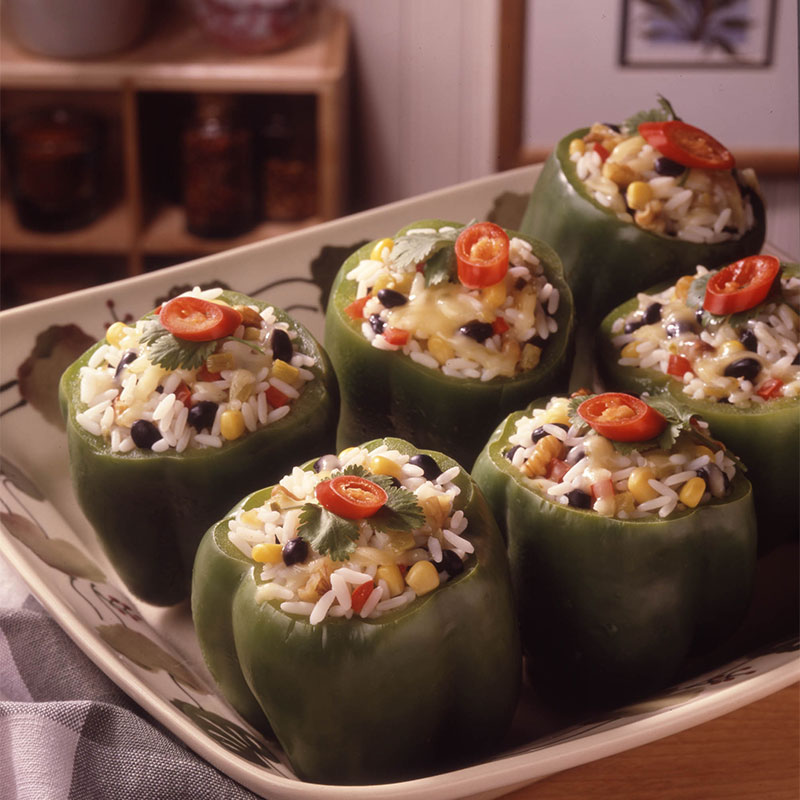 Smoked Corn Stuffed Peppers Overhead shot of 6 Smoked Corn Stuffed Peppers on a serving platter.