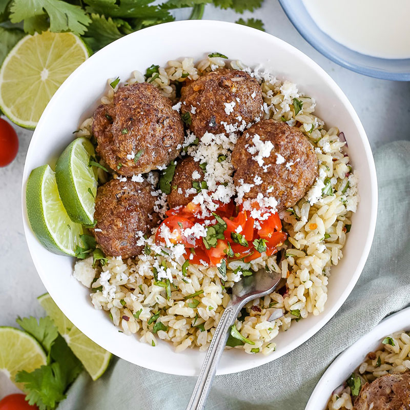 Overhead view of a bowl of Smoky Chipotle Meatballs with Cilantro Lime Rice.